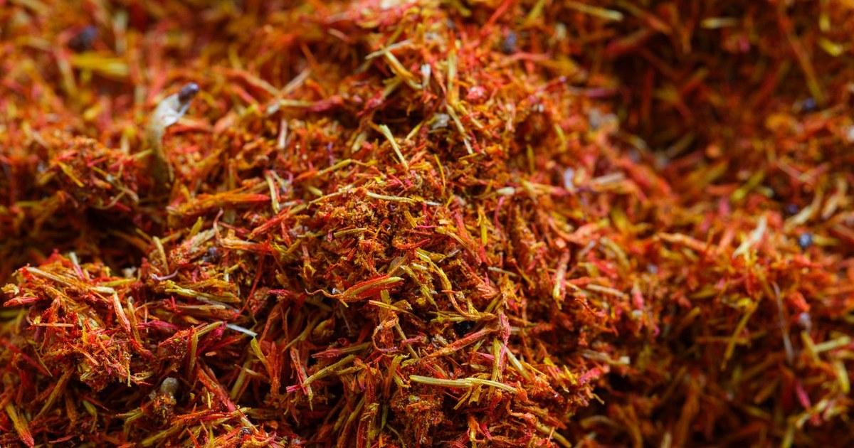 A close-up of vibrant red and orange saffron threads filling the frame