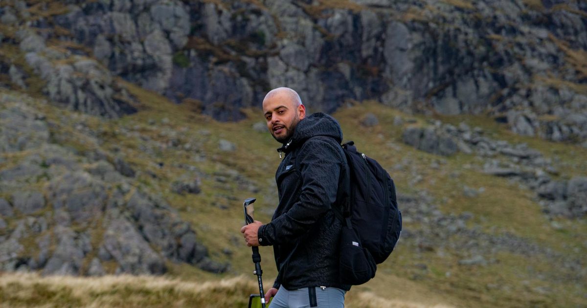 A man hiking in a rugged mountain landscape