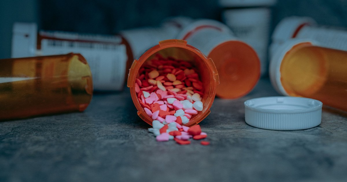 Amber prescription medication bottles with pills spilling out