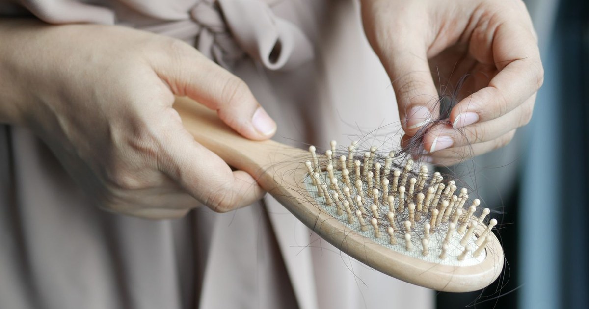 A hairbrush with loose strands of hair